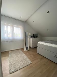 a bedroom with a bed and a dresser and a mirror at Pribe in Reiskirchen +3 photos