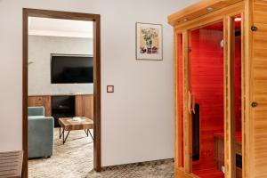 a living room with a door and a television at Hotel Sylwia in Sośnicowice +37 photos