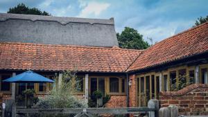 a brick house with a red roof at Avocet Cottage in Dunwich