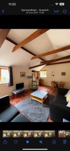 a living room with a couch and a table at Avocet Cottage in Dunwich
