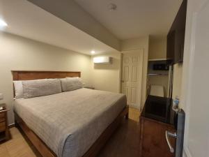a small bedroom with a bed and a television at Hotel Baja in Tijuana