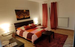 a bedroom with a bed and a table in it at Joly's Home in Luco neʼ Marsi
