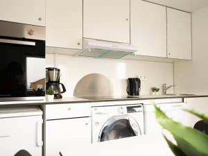 a kitchen with a washing machine in a kitchen at Budget Mobile House in Faroe Islands in Strendur +3 photos