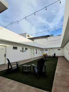 a courtyard with a table and a bench and a table at Hotel Baja in Tijuana