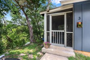 a blue house with a door with a potted plant at Lily Pad in Wimberley