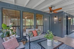a living room with a couch and a ceiling fan at Lily Pad in Wimberley