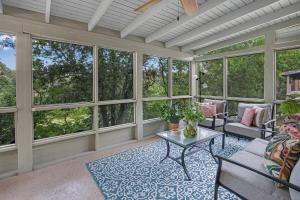 a screened in porch with windows and a table at Lily Pad in Wimberley