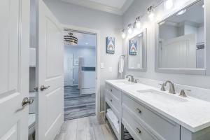 a white bathroom with two sinks and a mirror at The Flamingo Place in Rockport +52 photos