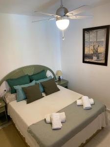 a bedroom with a large bed with two towels on it at EL DESCANSO in Calpe +18 photos