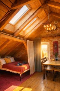 a bedroom with a bed and a table in a room at Apartamenty Dworzec Tleń in Tleń +41 photos