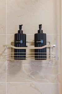 two bottles of soap on a shelf in a bathroom at Kokett Apartment in Neu-Ulm