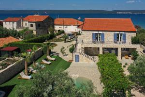an aerial view of a house with a swimming pool at Magna in Dobropoljana