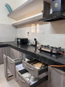 a kitchen with a stove and a counter top at Palm Stone Villa in Lucknow