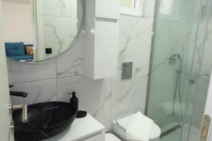 a bathroom with a black sink and a shower at Casa Bellora in Kamenari +8 photos