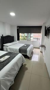 Llit o llits en una habitació de Hotel Cacique
