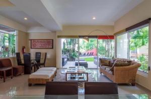 a living room with a couch and a table at Grand Blue Playa in Playa del Carmen