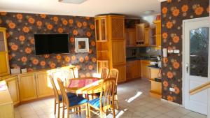 a kitchen with a table and chairs and a television at Aurora Premium Home in Győr