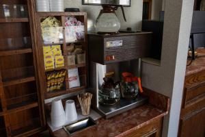 a small kitchen with a refrigerator with some food at Pacific Heights Inn in San Francisco