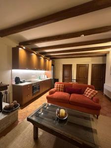a living room with a red couch and a table at Nostalgia Guesthouse Arachova in Arachova