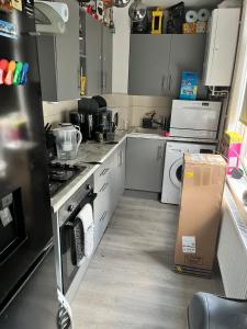 a kitchen with a cardboard box in the middle of it at Private Double Room near Bognor Beach! in Bognor Regis