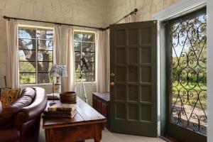 a living room with a green door and a couch at Live Oak Ranch in Spring Branch
