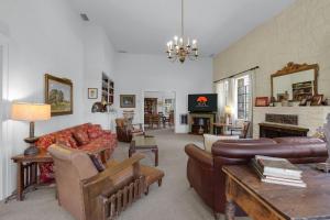 a living room with leather furniture and a fireplace at Live Oak Ranch in Spring Branch