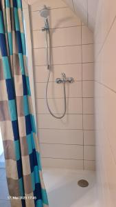 a shower in a bathroom with a shower curtain at My Pension City Stadtbergen Augsburg in Stadtbergen +58 photos