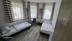 a hospital room with two beds and a table at My Pension City Stadtbergen Augsburg in Stadtbergen