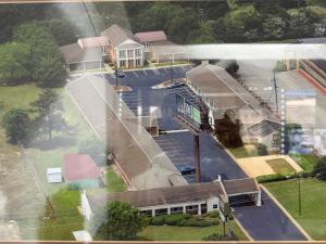 an aerial view of a building with a bus stop at Soho inn & suites in Perry