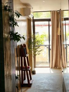 a room with a chair and a large window at Island Pod in El Nido