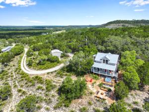 an aerial view of a house in the woods at Lomax Lookout in Wimberley