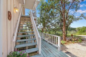 a staircase leading up to a house with trees at Lomax Lookout in Wimberley