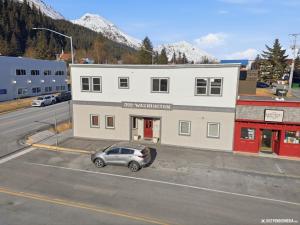a car parked in a parking lot in front of a building at Hotel North in Seward