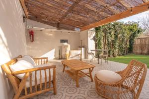 a patio with chairs and a table and a table at Marrakech Cinéma Jacuzzi - Suite romantique in Feyzin