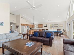 a living room with a couch and a table at Swan Shores-Expansive Lakefront Home with Private Dock in Grand Junction
