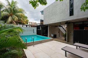 a swimming pool in the backyard of a house at The Quiet Garden in Jacó