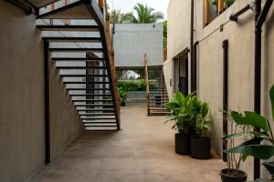 a hallway with stairs in a building with plants at The Quiet Garden in Jacó