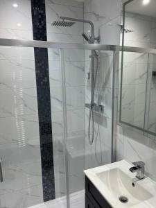 a white bathroom with a shower and a sink at The Ivy in Marston Green +23 photos