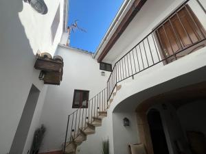 a stairway leading up to a building with a stair case at Apartamentos Cañón de la Rinconada in Trujillo