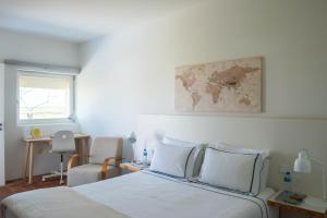 a bedroom with a bed with a map on the wall at Tavira Convent, 2-bedroom, condo, pool in Tavira +45 photos