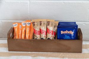 a wooden box filled with toothbrushes and books at Windsurfer Beach Chalet 3 in Lancelin +4 photos