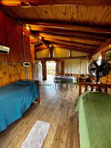a bedroom with a bed and a table in a room at Amaneceres de San Isidro in José de la Quintana