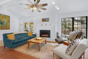 a living room with a blue couch and a fireplace at Red Bird Cottage in Wimberley