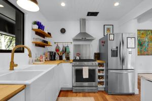 a kitchen with a stove and a refrigerator at Red Bird Cottage in Wimberley