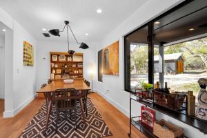a dining room with a table and a large window at Red Bird Cottage in Wimberley +33 photos