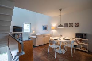 a living room with a table and chairs and a couch at Tavira Convent, 2-bedroom, condo, pool in Tavira