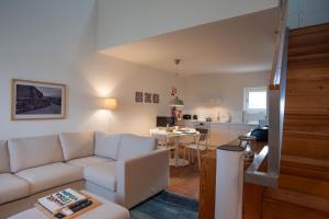a living room with a white couch and a kitchen at Tavira Convent, 2-bedroom, condo, pool in Tavira