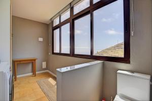 an empty bathroom with a large window and a toilet at VV La Karajita in Mazo +16 photos