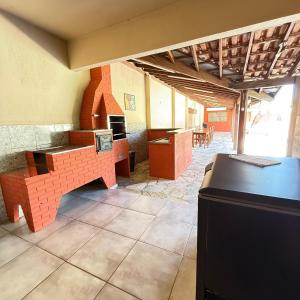 a waiting room with desks and tables in a building at Chacara Italia in Uberaba