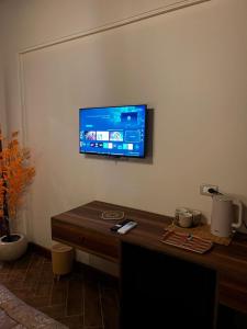 a flat screen tv on a wall in a living room at 44 Inn in Dahab +10 photos